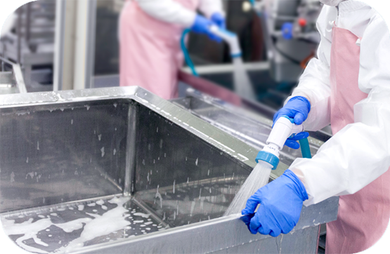 Factory workers cleaning utensils using Sanistar Water